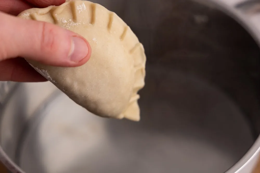 Placing pierogi in boiling water