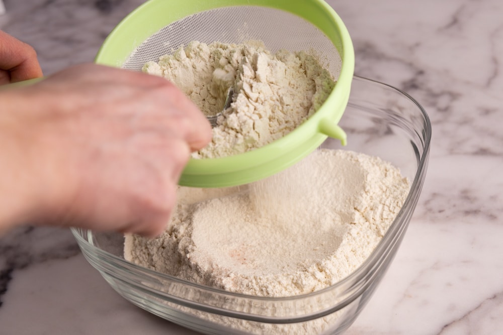 Sifting flour for pierogi dough