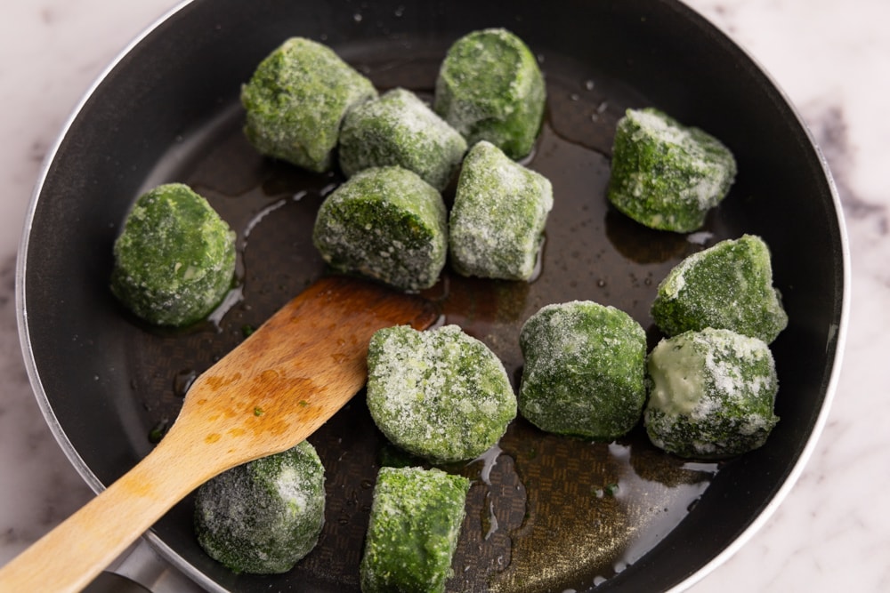 Defrosting spinach in a skillet