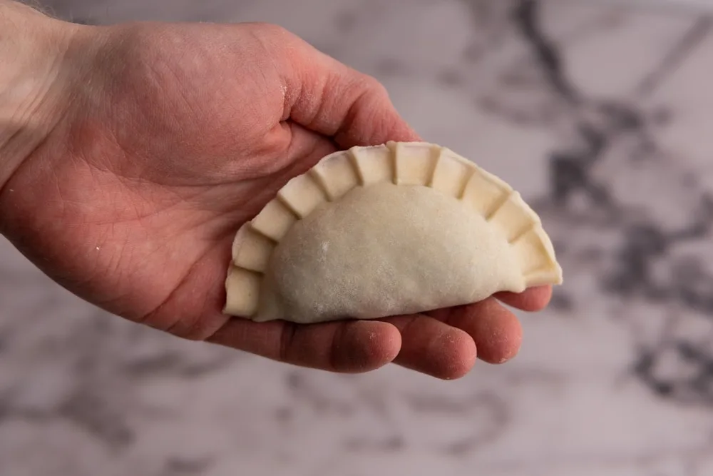 Pierogi maker formed spinach pierogi