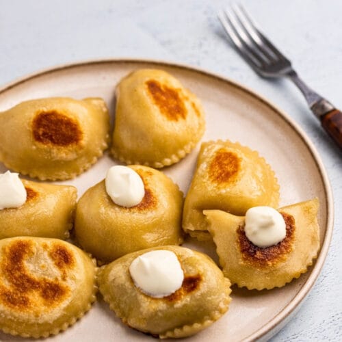 Potato and cheese pierogi served