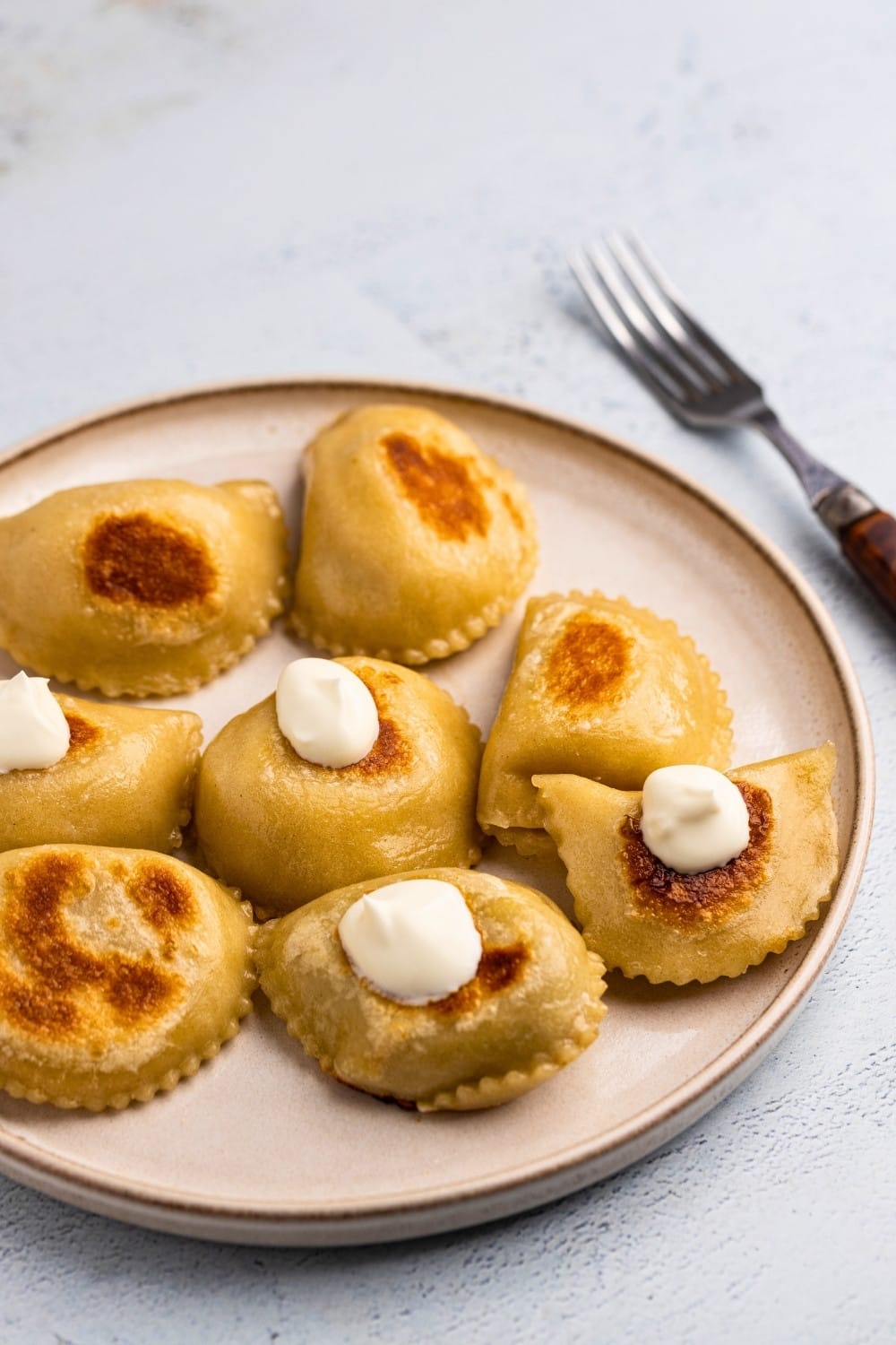 Potato and cheese pierogi served