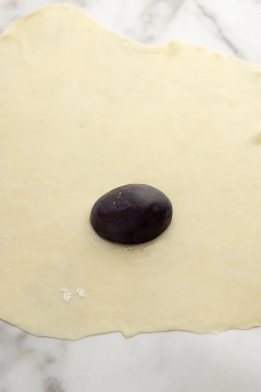 Plum on pierogi dough