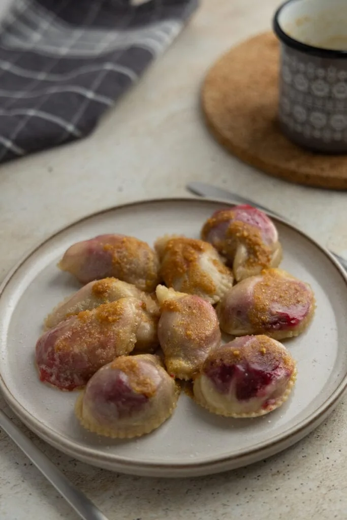 Plum pierogi with buttered breadcrumbs served