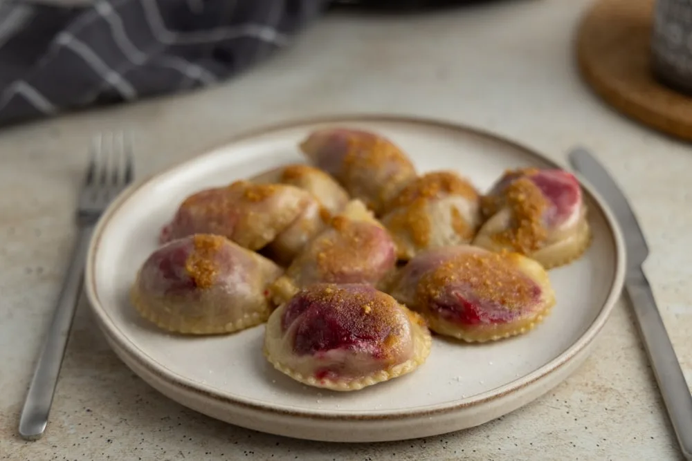 Plum pierogi with buttered breadcrumbs