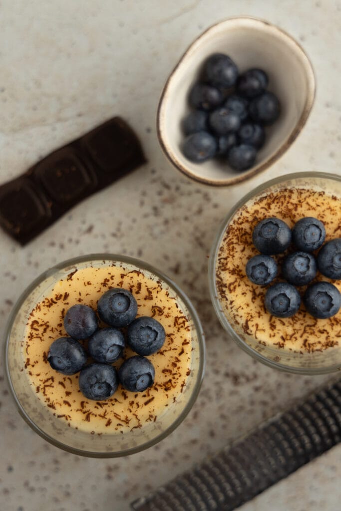 Polish vanilla pudding topped with dark chocolate and blueberries