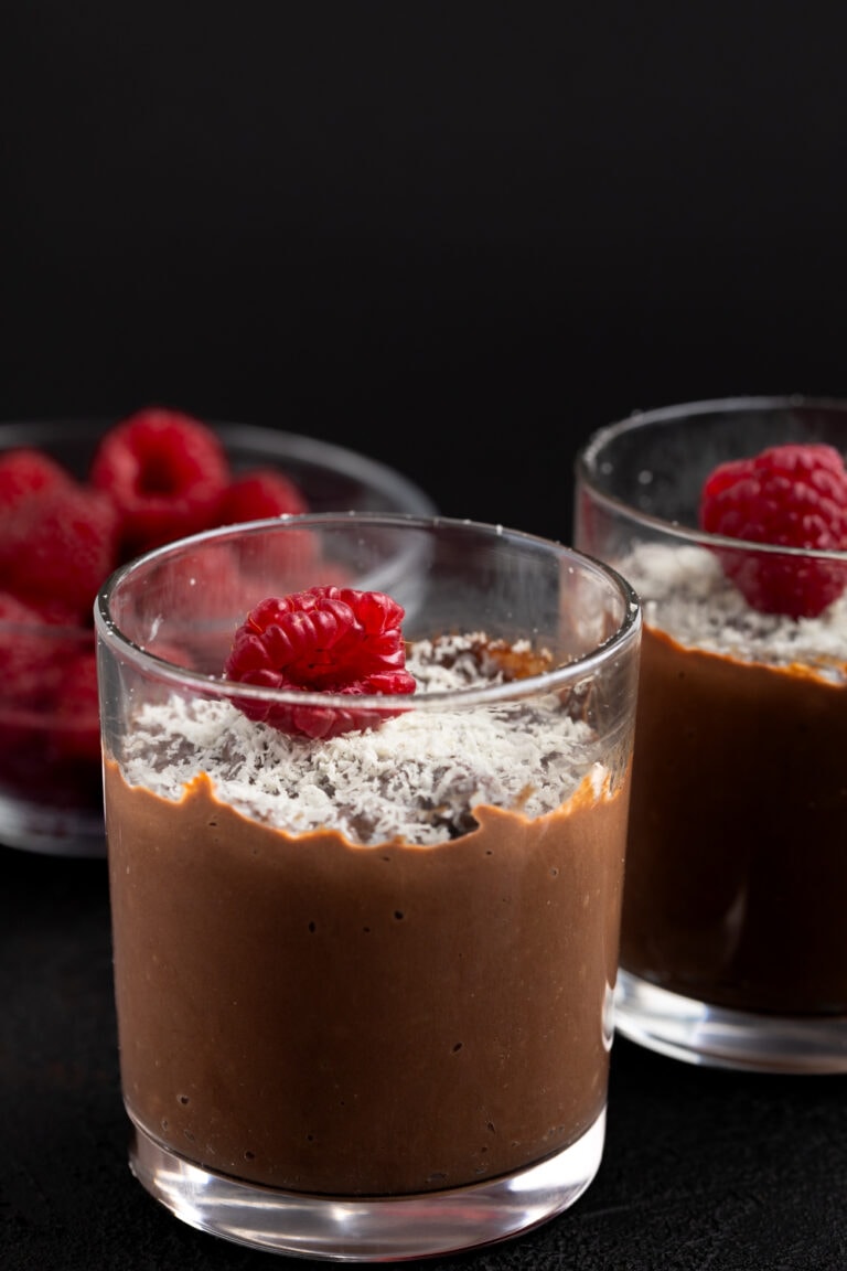 Polish chocolate pudding topped with grated white chocolate and raspberries