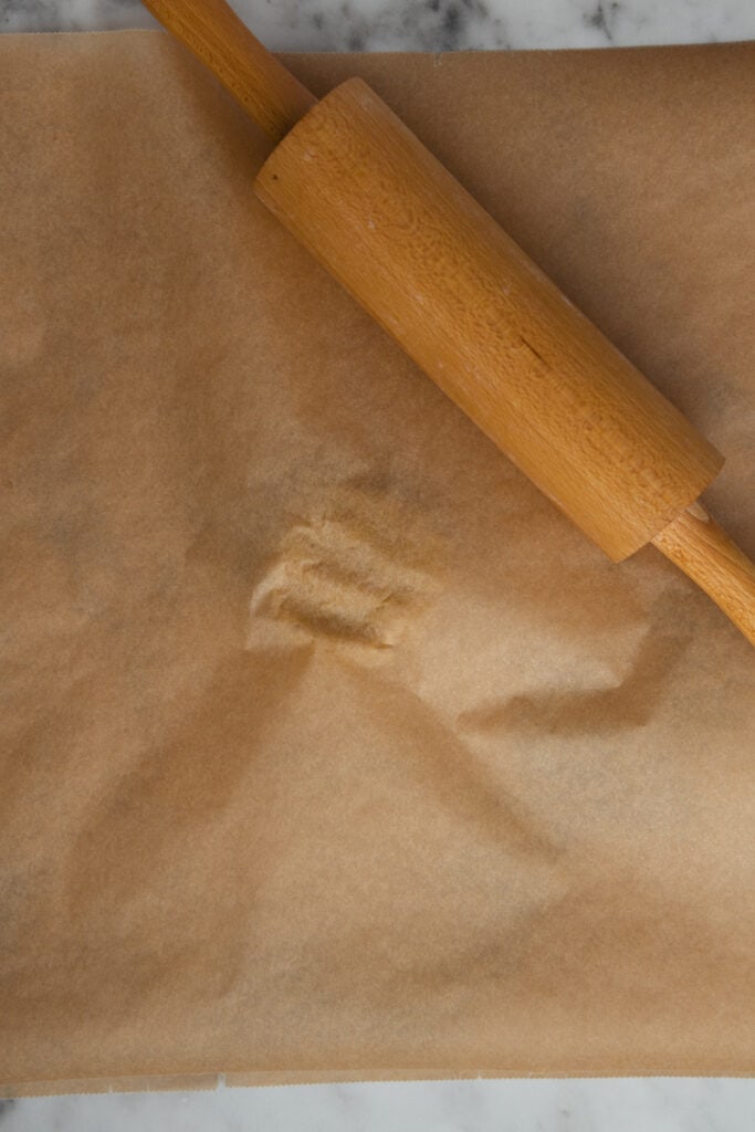 Covering dough with parchment paper