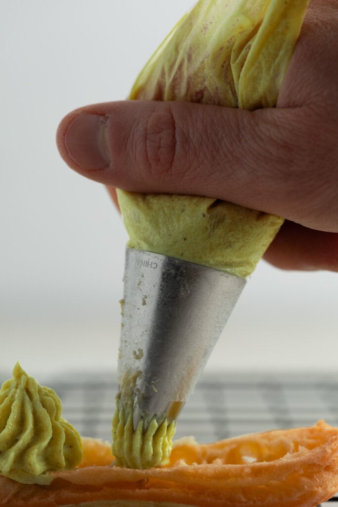 Piping pistachio pastry cream