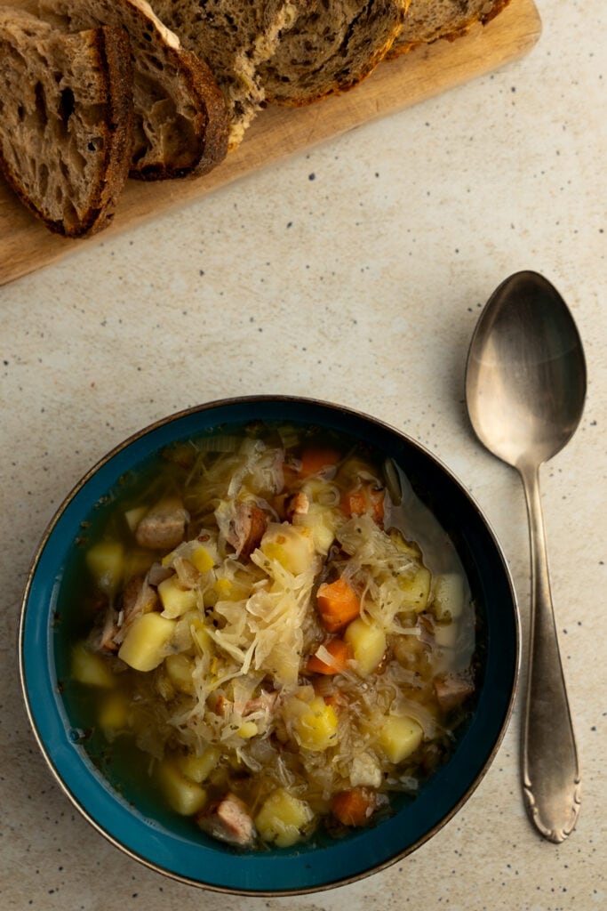 Polish sauerkraut soup served with crusty bread 