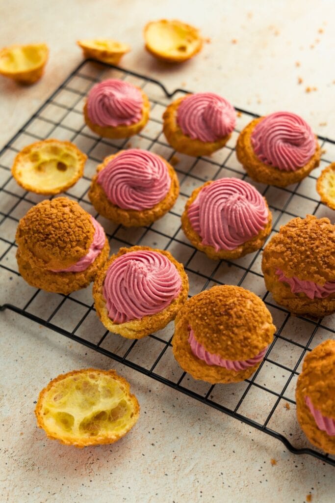 Streusel-coated cream puffs filled with raspberry pastry cream