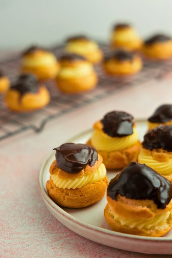 Cream puffs filled with vanilla pastry cream and topped with ganache