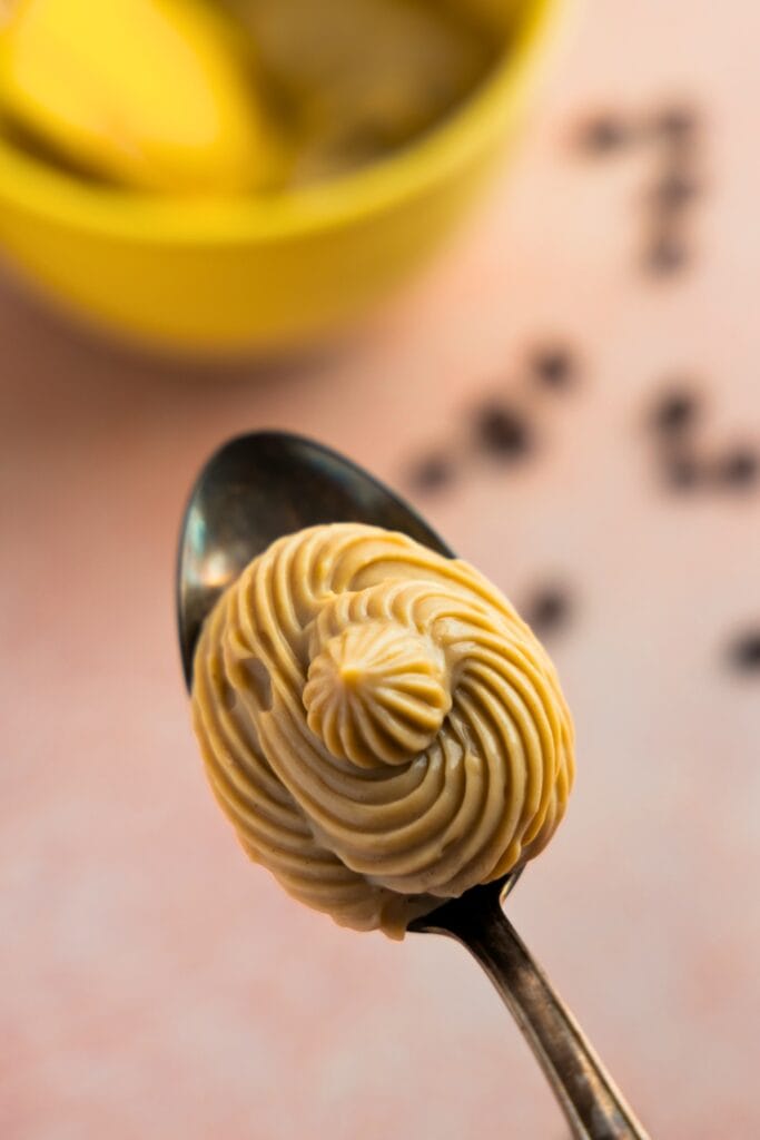 Piped coffee pastry cream in a spoon
