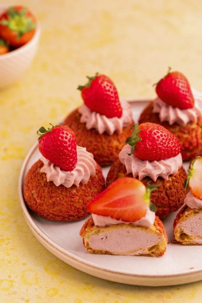 Cream puffs stuffed with strawberry diplomat cream