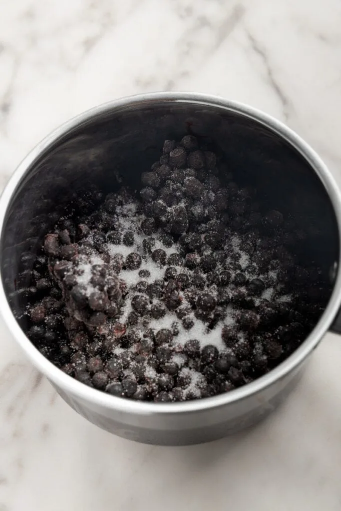 Adding blueberries and sugar