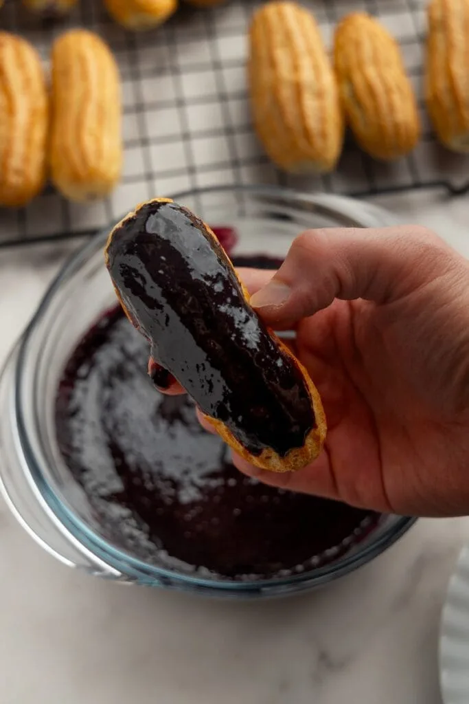 Blueberry eclair dipped in ganache