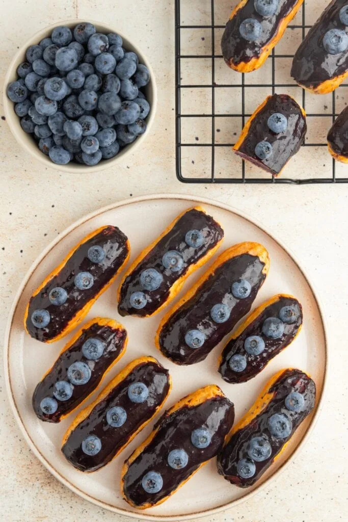Blueberry mascarpone-filled eclairs with blueberry ganache topping