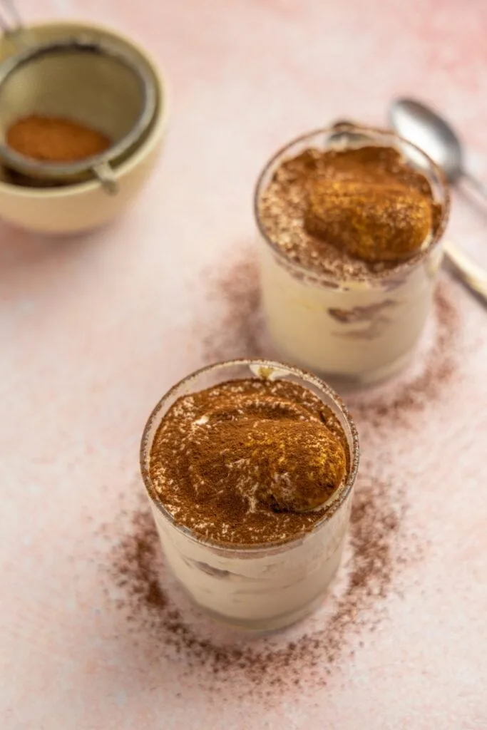 Tiramisu for two, served in small dessert glasses.
