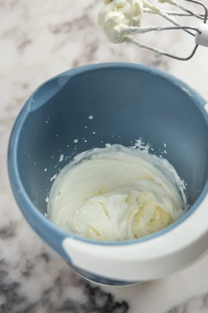 Whip mascarpone and heavy cream together
