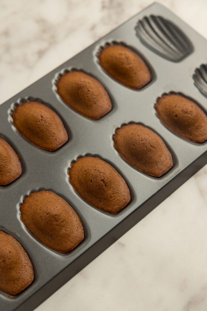Chocolate madeleines in a tin pan