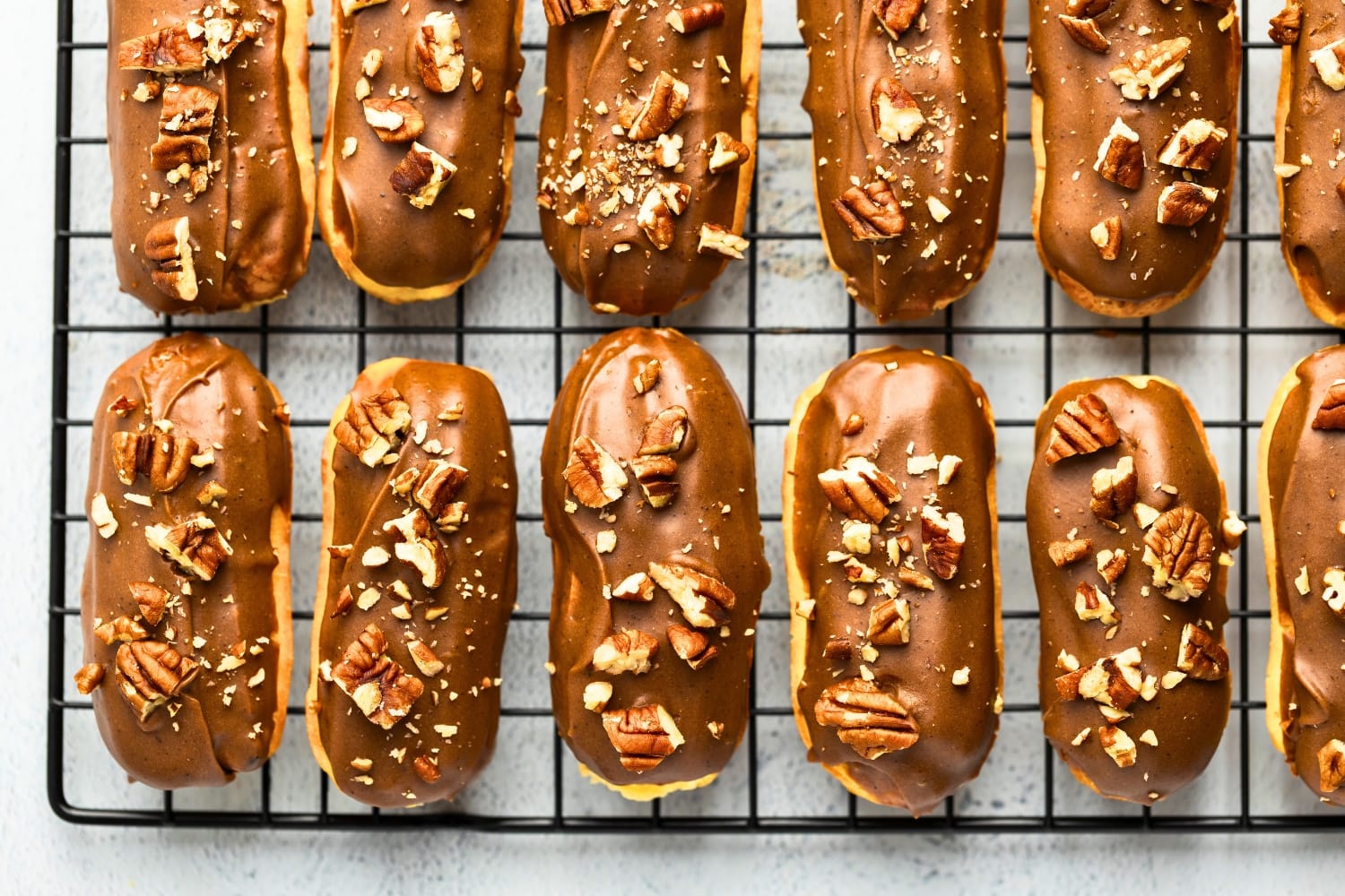 Eclairs covered in brown butter ganache and filled with vanilla cream