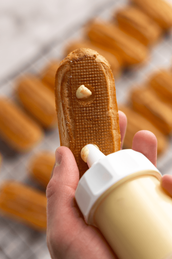 Filling the eclair with pastry cream