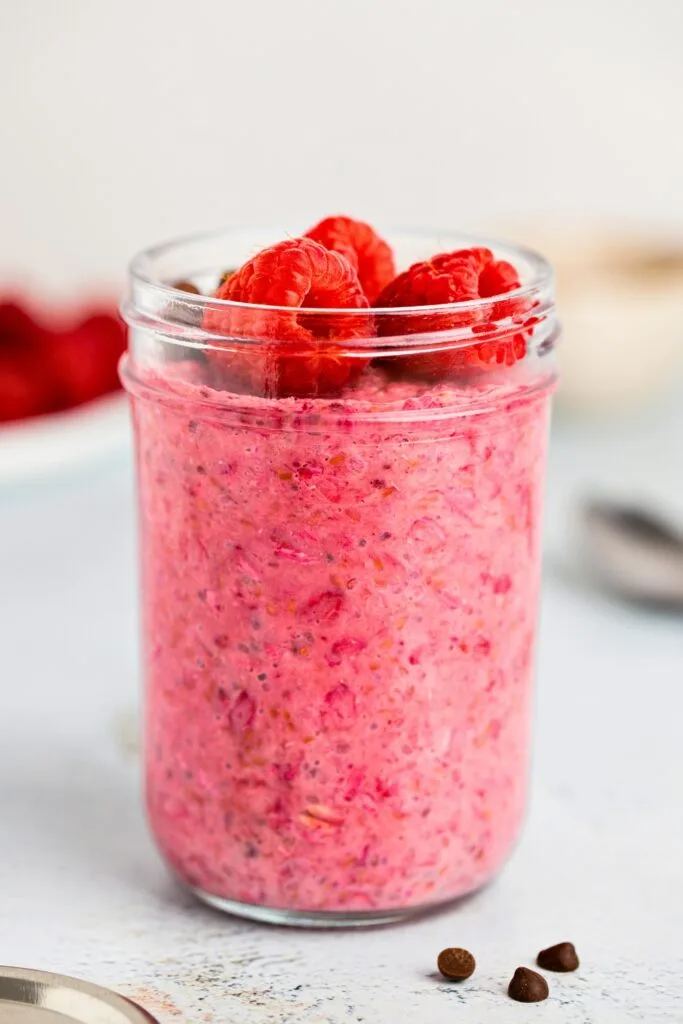 Morning jar of raspberry overnight oats with chia seeds