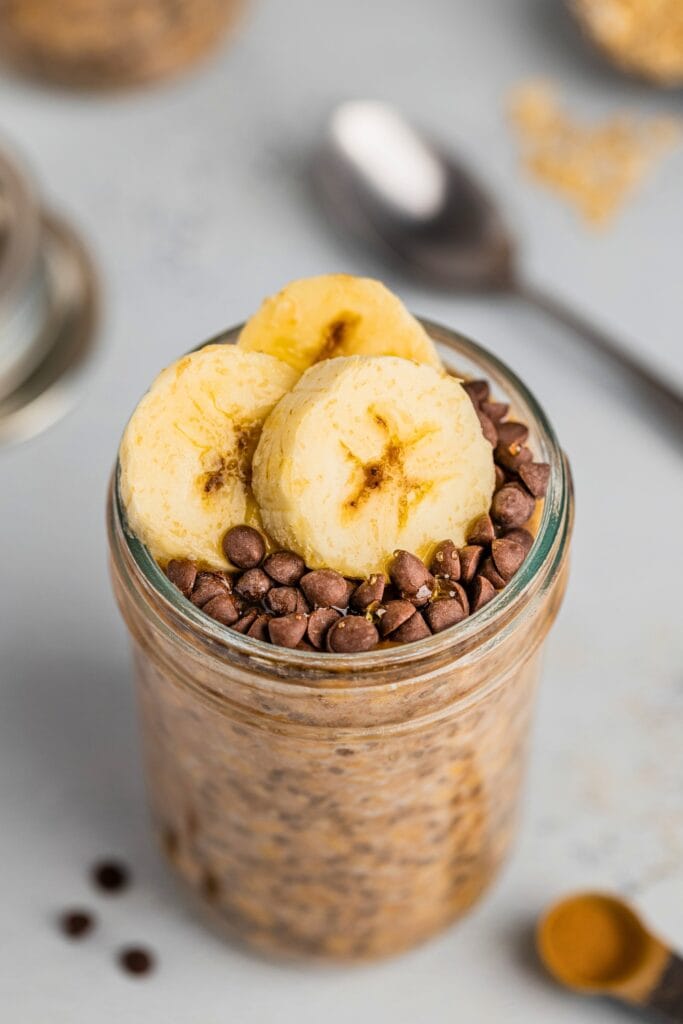 A glass jar of chocolate banana overnight oats