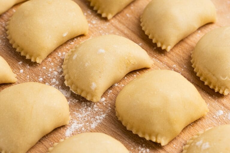 Pierogi arranged on a wooden cutting board