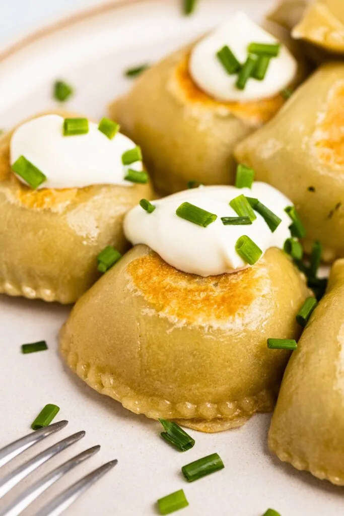 Plated spinach filled pierogi