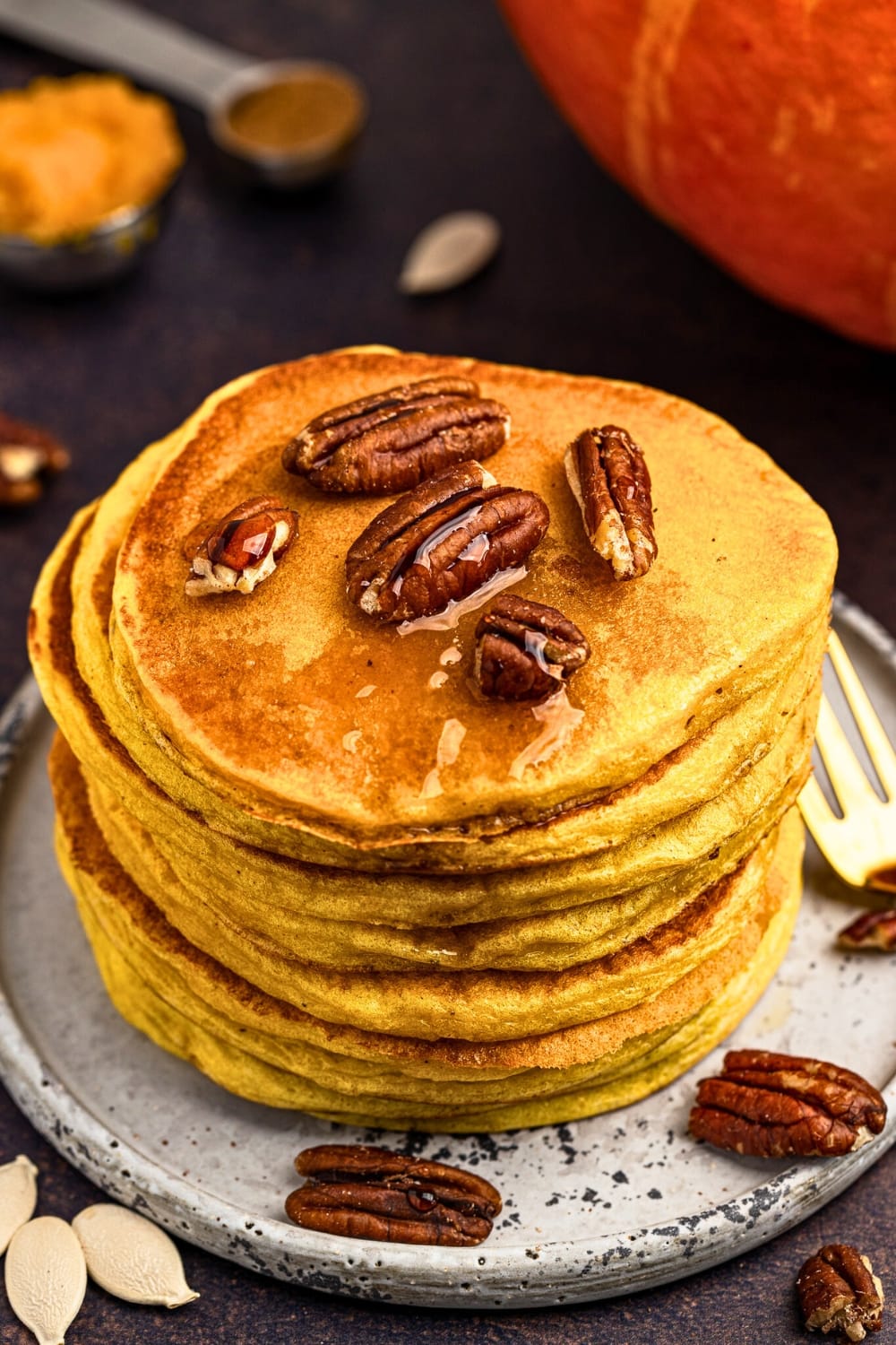 Delicious pumpkin cottage cheese pancakes topped with maple syrup and pecans