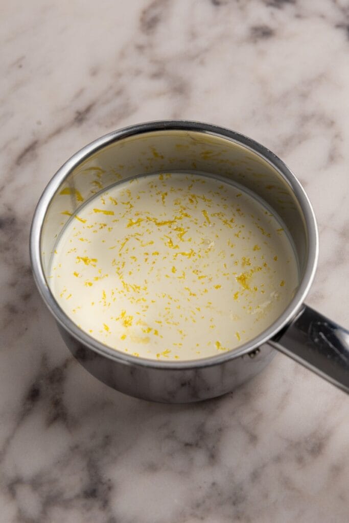 Heavy cream sugar and lemon zest in a bowl