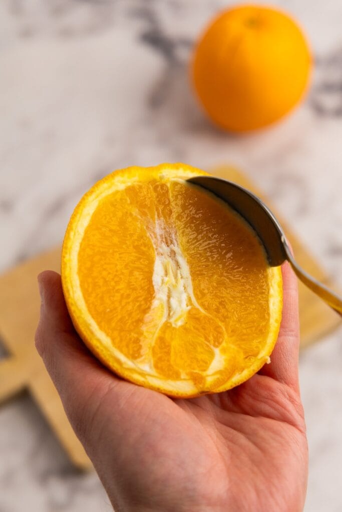Scooping out the orange flesh