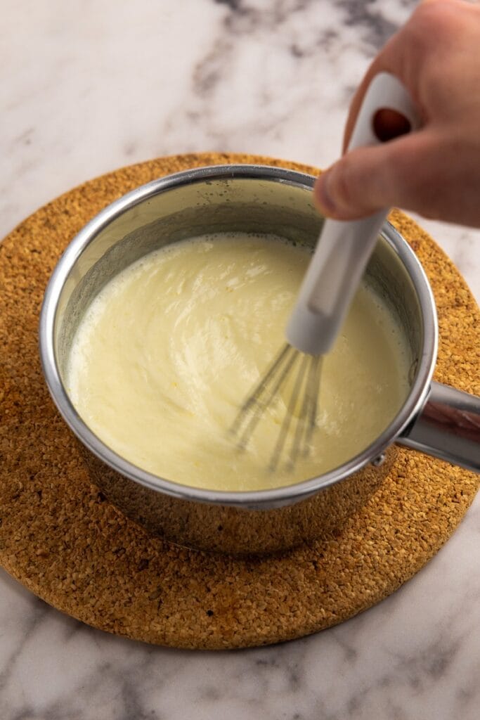 Stirring in the lemon and heavy cream mixture