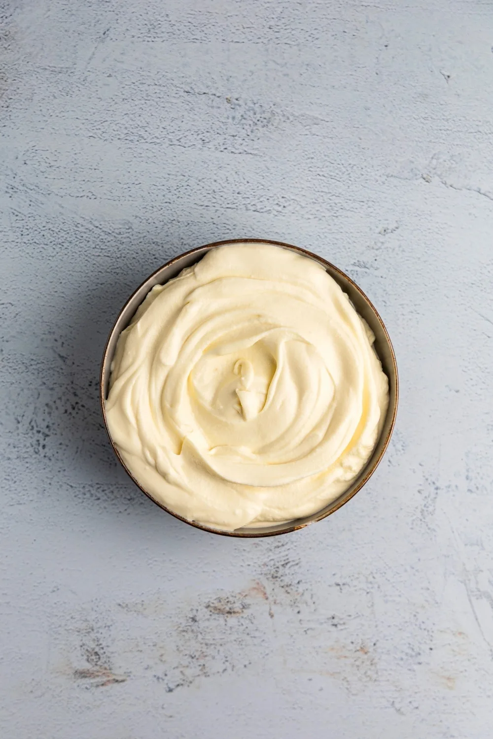 White chocolate mascarpone cream in bowl topdown