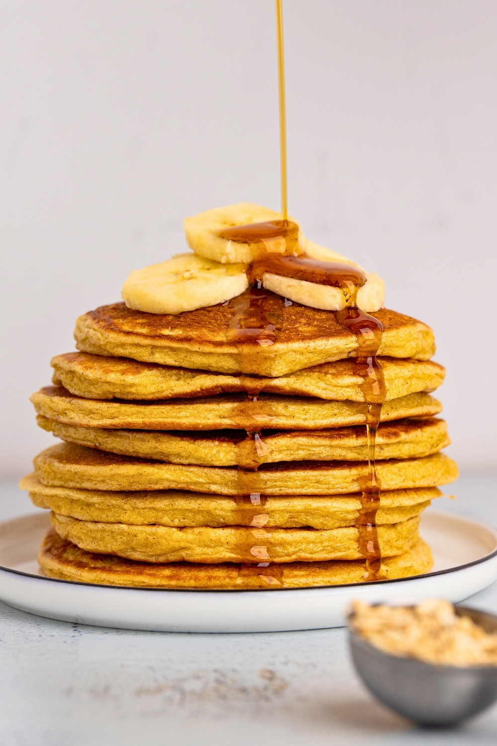 Cottage cheese oats pancakes pouring maple top