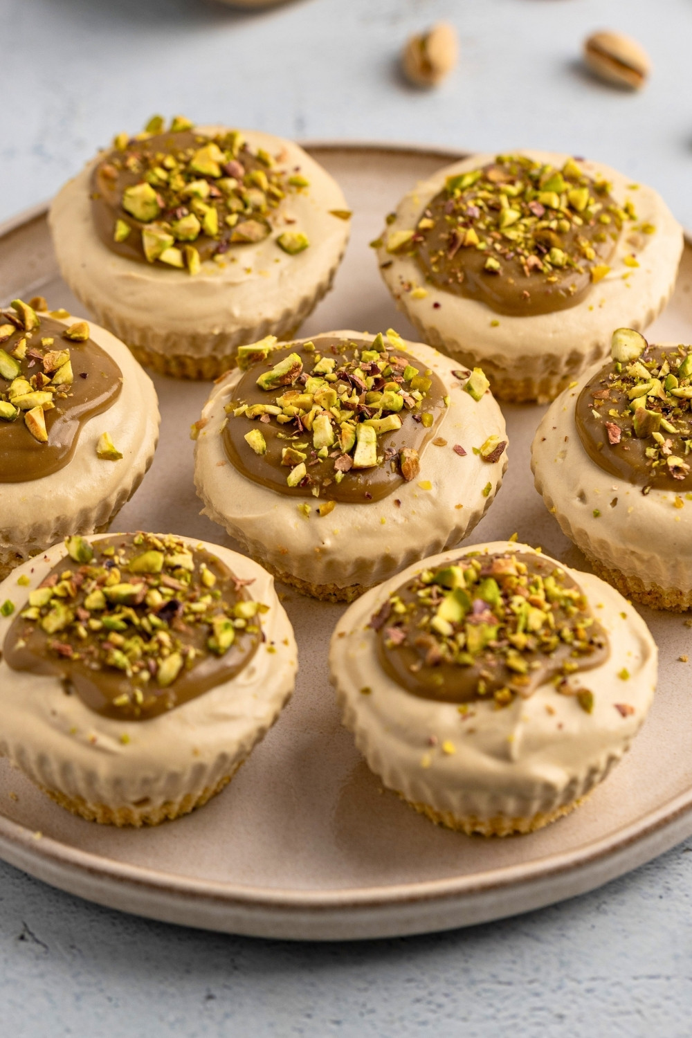 Mini pistachio cheesecakes plated closeup