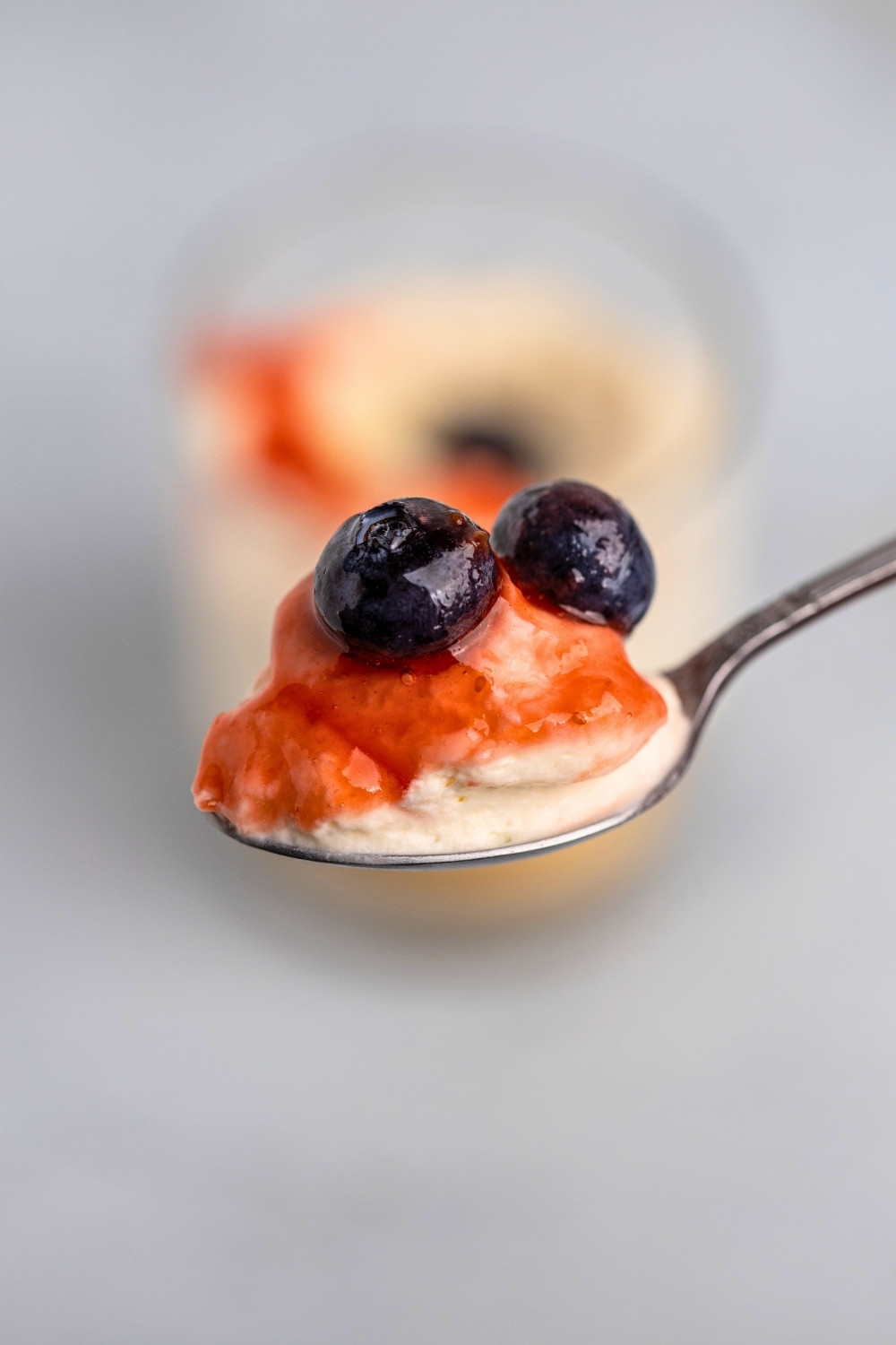 Vanilla cheesecake cups spoon closeup